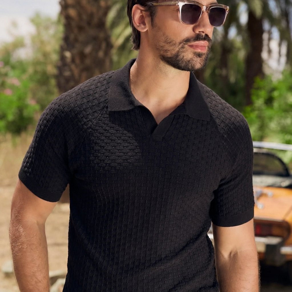 Man in a black knitted polo wearing Somnia Champagne Gold sunglasses
