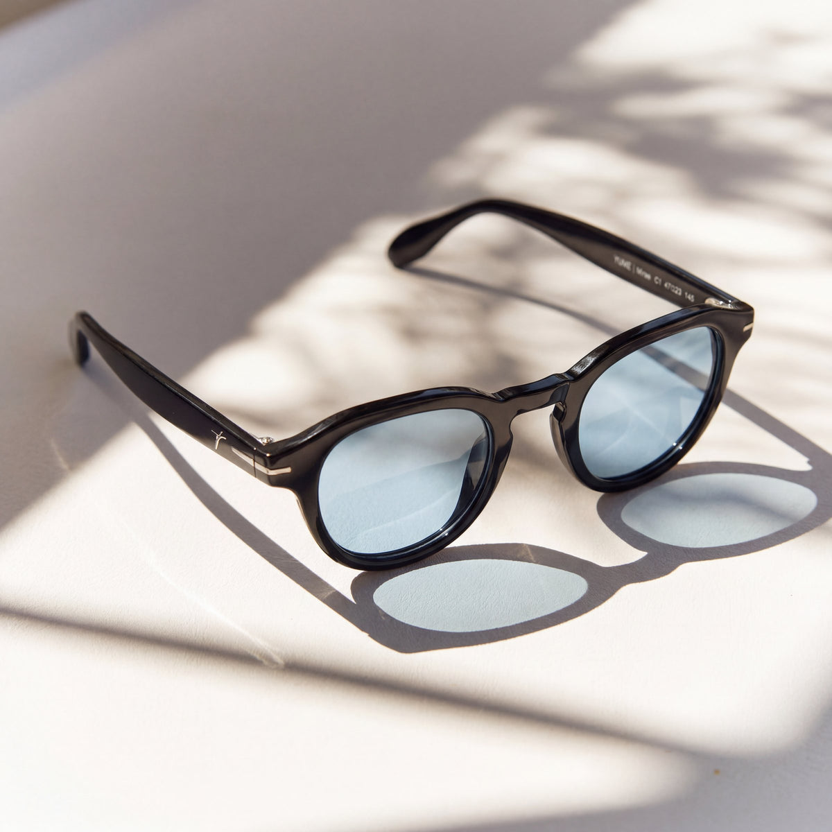 Mirae Black/Blue sunglasses, black round frame with light blue lenses