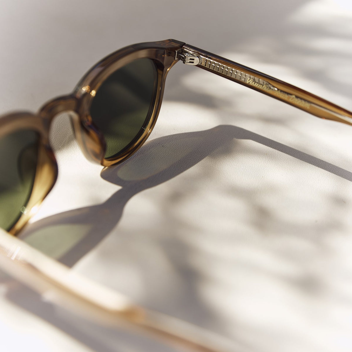 Noxie Brown/Green sunglasses, angled view of the amber frame