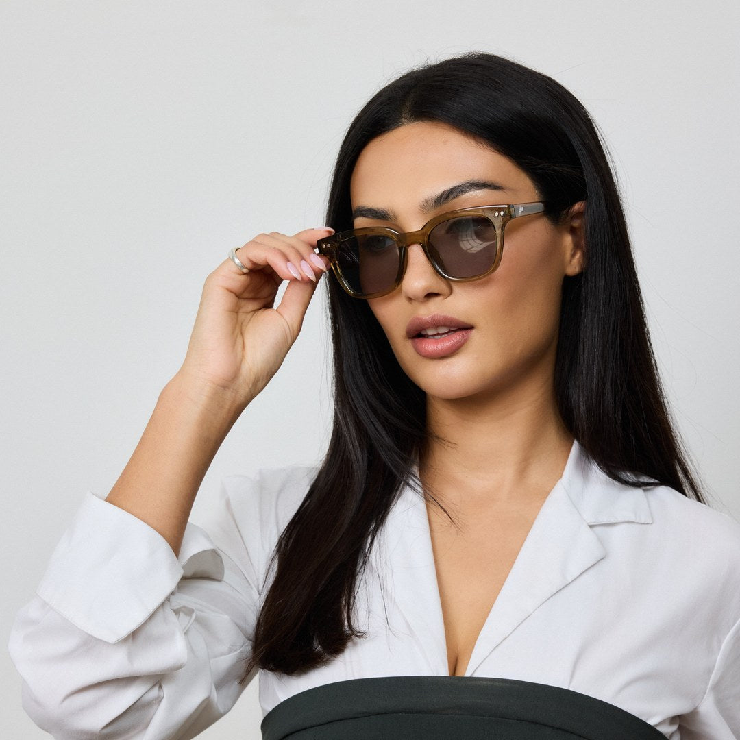 Woman wearing Yume Velora Desert Green Gold sunglasses