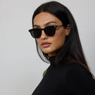 Woman wearing Yume Lucid Black sunglasses