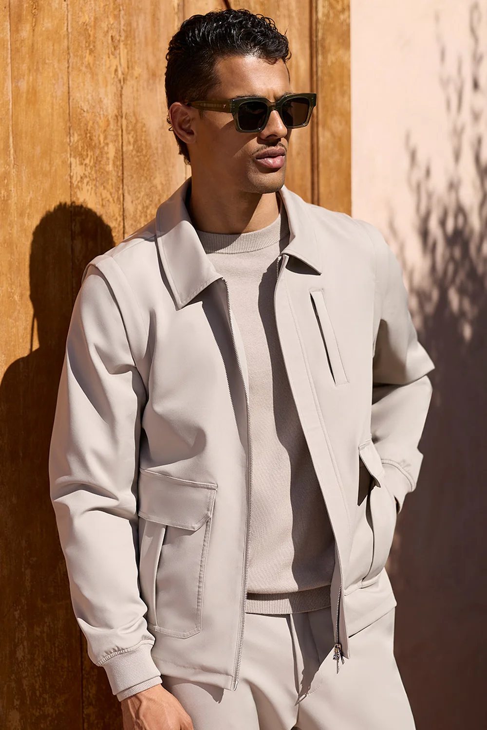 Man wearing Celuna Olive square sunglasses with a stone zip jacket