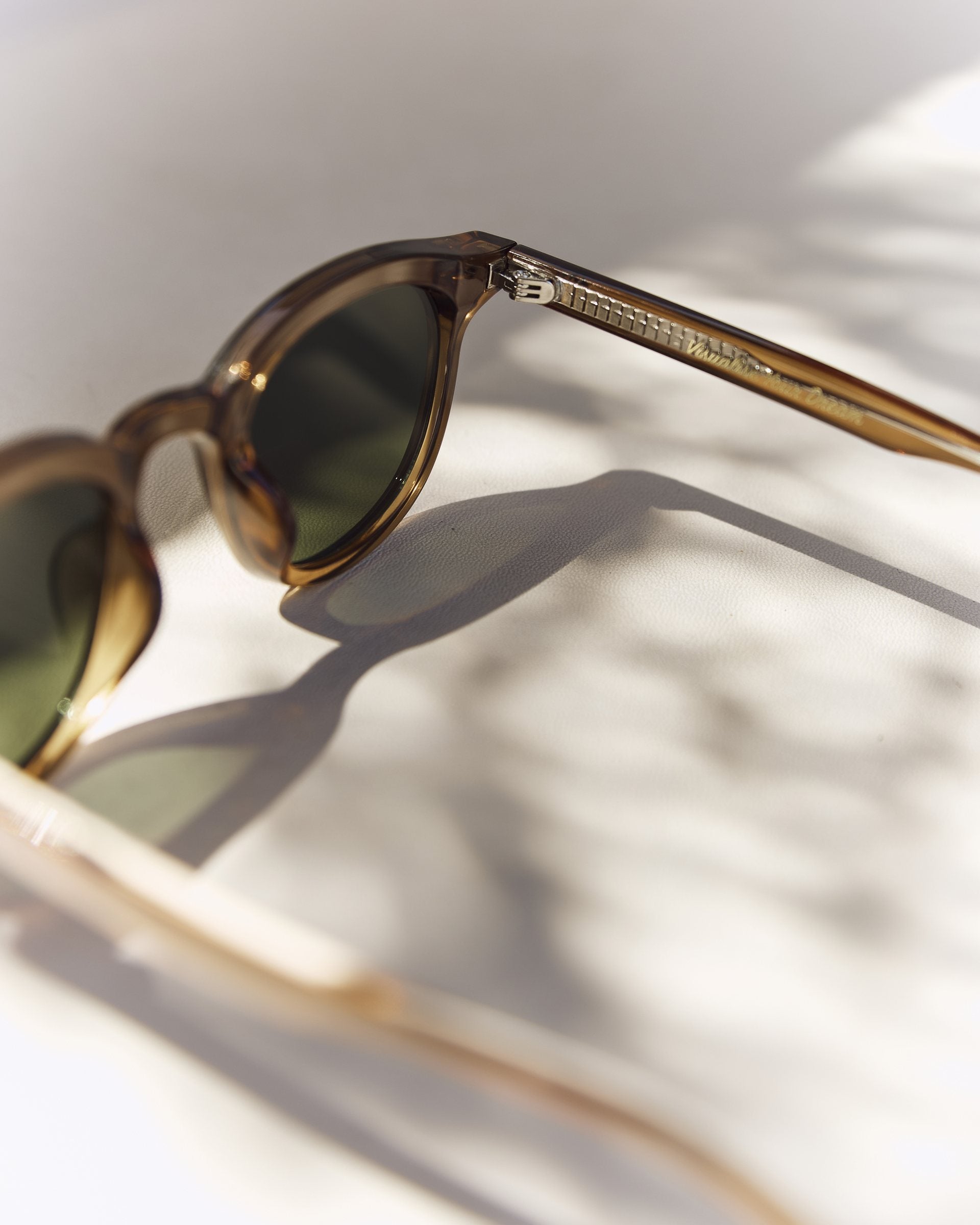 Noxie Brown/Green sunglasses, angled view of the amber frame